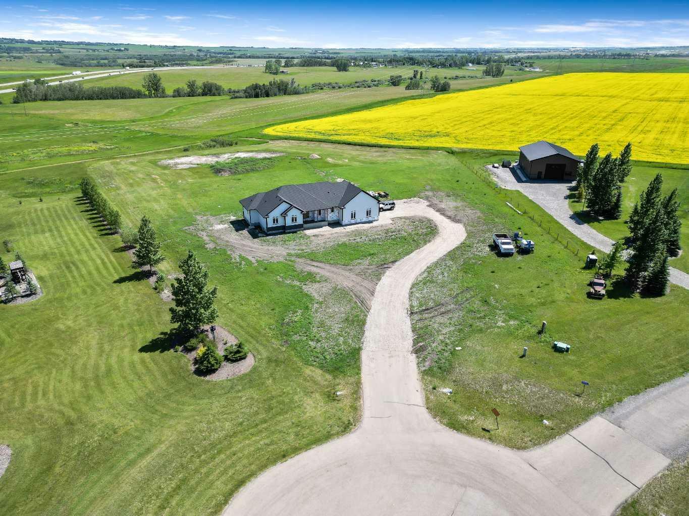 Property Photo: 349062 Tamarack Drive E AB T1S 5B8