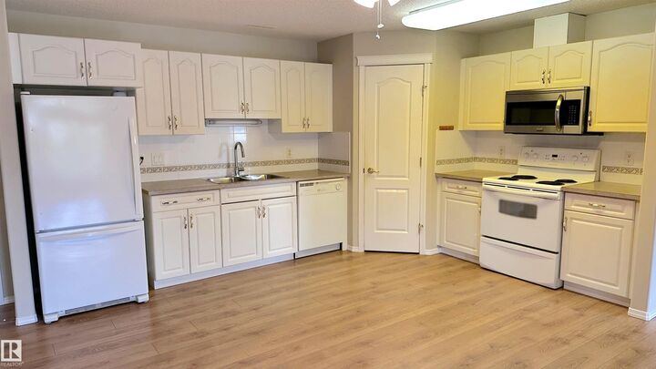 Property Photo: 237 Youville Drive NW 218 AB T6L 7G2