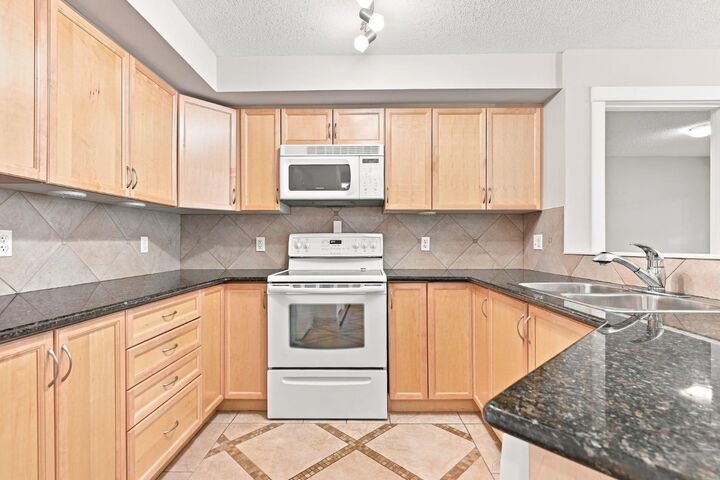 Property Photo:  5200 44 Avenue NE 2103  AB T1Y 7L4 