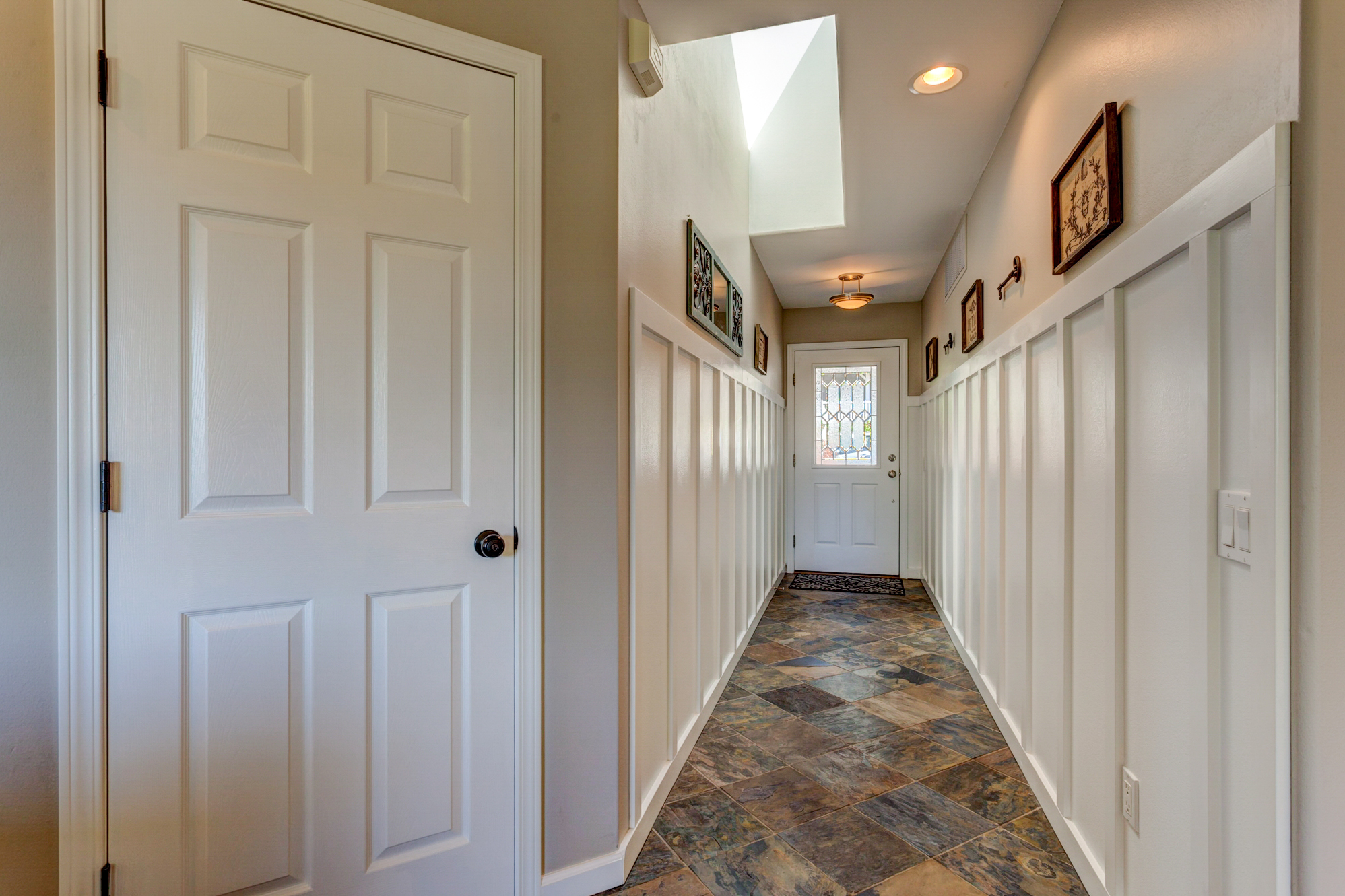 Property Photo: Once inside, you will see the craftsman like details of the home, such as the wood wainscoting at the entry and slate flooring, with the skylight allowing the natural light to stream in. 3817 Fielding Ave  WA 98229 